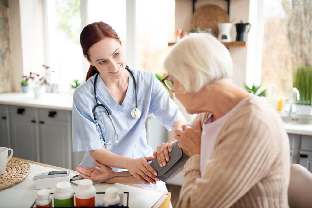 nurse wearing uniform measuring blood pressure